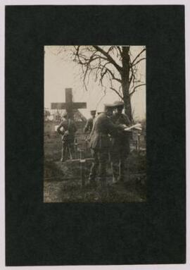 Photograph of Major Wheldon with 3 other men in uniform [officers?], in a field cemetery, France,