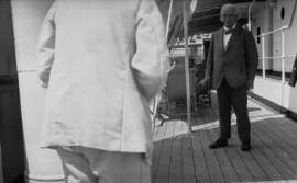 [A man in tropical whites photographing Lloyd George]