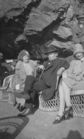 [David, Margaret and Megan Lloyd George sitting in wicker chairs, location unknown]