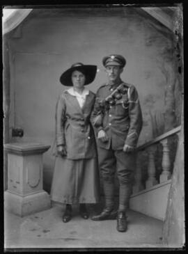 [Lance corporal, Army Service Corps arm in arm with a young lady]