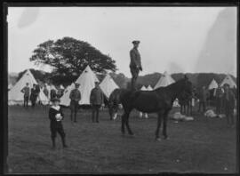 [Military Camp - Man standing on horse]
