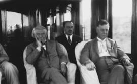 [David Lloyd George and two other men, all seated]