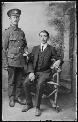 [Royal Engineer wearing Wheelwright Trade badge and photographed with a civilian]