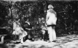 [David and Margaret Lloyd George with another couple in woodland]