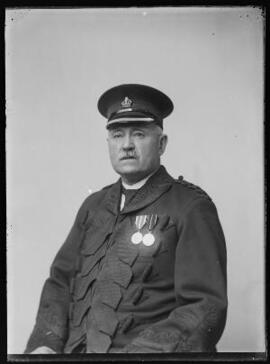 [Senior Police Officer with medals]